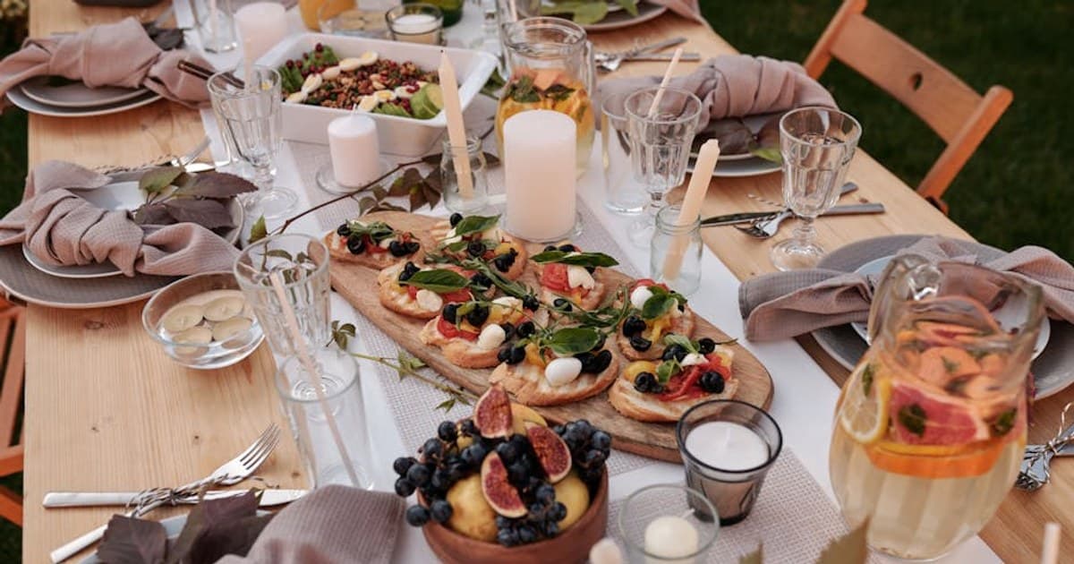 Charming outdoor dining setup with gourmet dishes and refreshing beverages, ideal for celebrations.