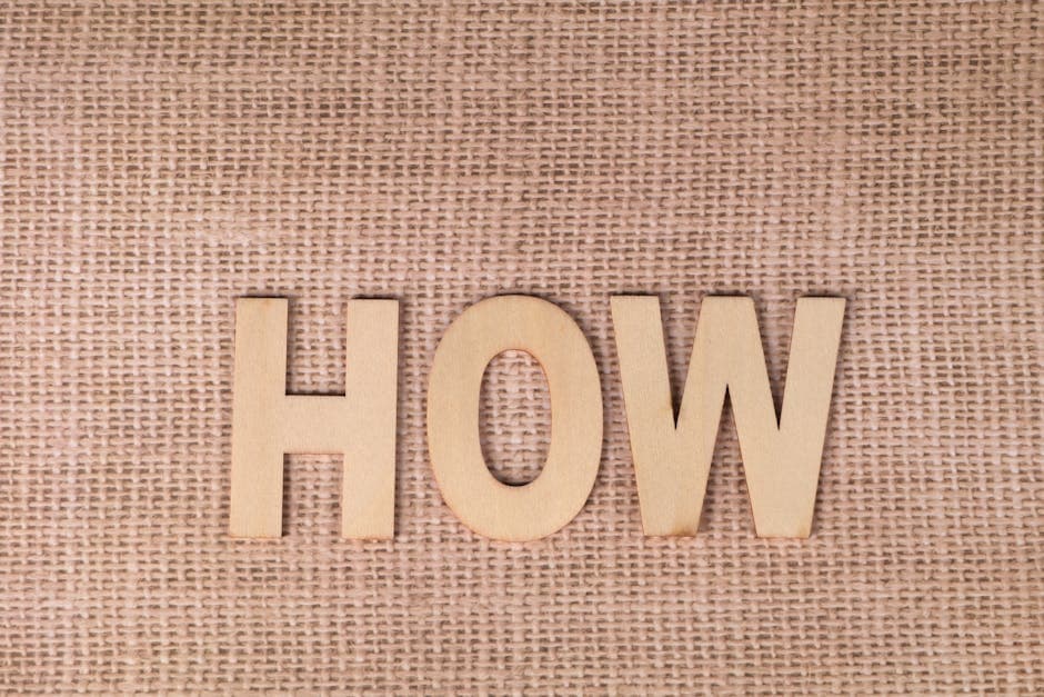 Word 'HOW' formed with wooden letters on textured burlap surface.