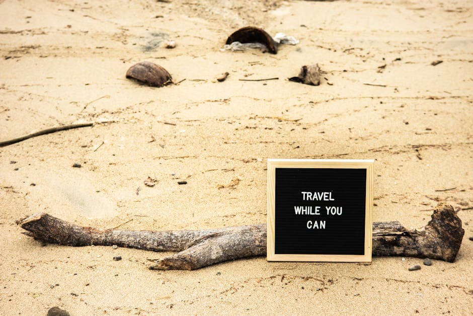 Motivational sign on sandy beach prompts travelers to seize the moment. Perfect for travel inspiration.