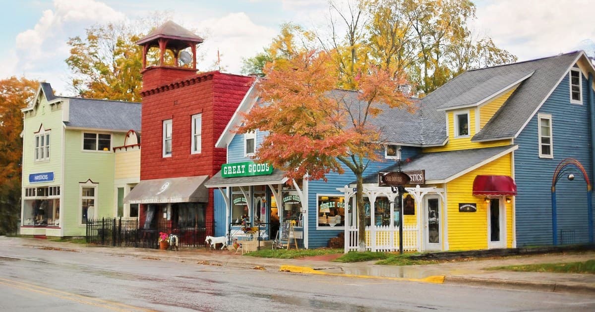 A vibrant street scene with colorful buildings and quaint shops under autumn skies.
